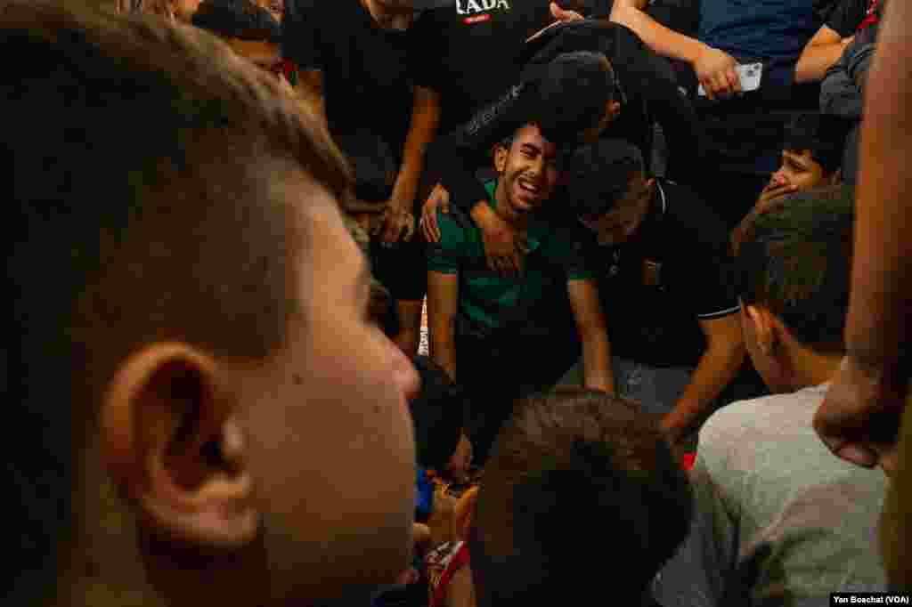 Relatives of Ahmad Ghaleb, 16, killed by the Israeli forces, cry during prayers in the local mosque, in Qalandia Refugee Camp, Oct. 25, 2023.