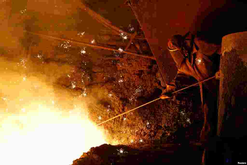 An employee carries out operations during the production of iron at Yenakiyeve Iron and Steel Works in the course of Russia-Ukraine conflict in Yenakiyeve in the Donetsk region, Russian-controlled Ukraine.