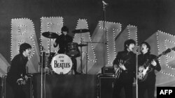 FILE - This photo taken on June 30, 1966 shows The Beatles, (L to R) Paul McCartney, Ringo Starr, George Harrison and John Lennon, performing during their concert at the Budokan in Tokyo.