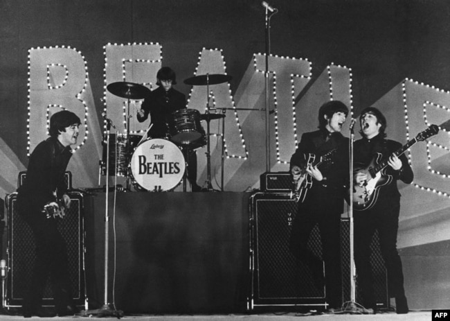 FILE - This photo taken on June 30, 1966 shows The Beatles, (L to R) Paul McCartney, Ringo Starr, George Harrison and John Lennon, performing during their concert at the Budokan in Tokyo. (Photo by JIJI PRESS / JIJI PRESS / AFP)