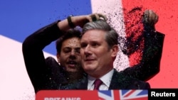 A protester throws confetti on Britain&#39;s Labour Party Leader Keir Starmer at the party&#39;s annual conference in Liverpool.