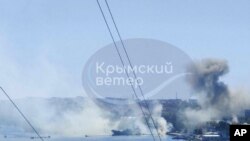 FILE - This image from video shows smoke rising from a Ukrainian missile strike at Russia’s Black Sea fleet headquarters in Sevastopol, Crimea, Sept. 22, 2023. Russia said Dec. 15, 2023, that it had shot down 26 drones over the Crimean Peninsula. 