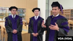 Behruz Shamsuddinov, right, speaks while Doniyorbek Davronov, middle, and Azizjon Jamolov from Penn State Law's Class of 2024 talk with VOA in State College, Pennsylvania, May 10, 2024.