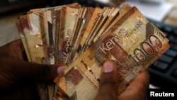 FILE — Kenyan currency notes are pictured inside a cashier's booth at an Equity Bank branch, Nairobi, May 16 2023. 