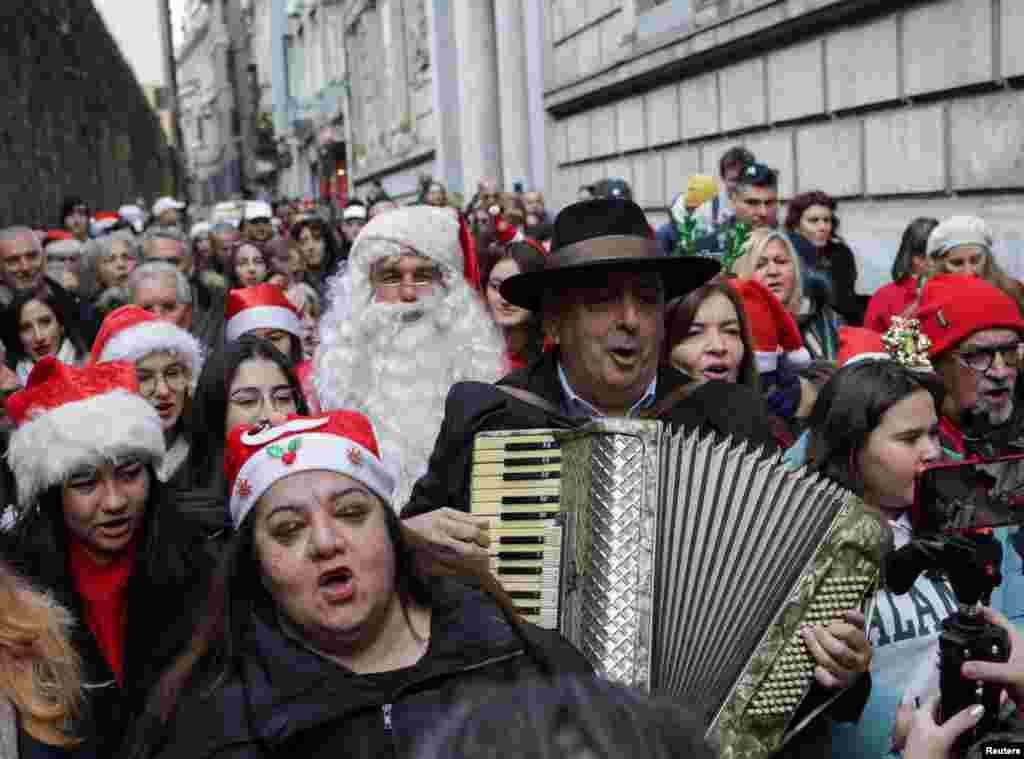 Zografyon Greek High School principal Yani Demircioglu plays an accordion, accompanied by school children and members of Greek Orthodox community, during a Christmas celebration in central Istanbul, Turkey.