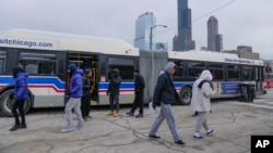 Chicago Transit Authority "warming" buses are parked in the 800 block of South Desplaines Street, Jan. 11, 2024, in the city's latest attempt to provide shelter to incoming migrants.