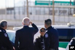 FILE - U.S, President Joe Biden looks toward a large "Welcome to Mexico" sign over the Bridge of the Americas as he tours the El Paso port of entry along the US-Mexico border, in El Paso, Texas, Jan. 8, 2023.