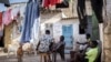 CORRECTS FAMILY NAME TO NDIAYE - Salamba Ndiaye, center, a 28-year-old who tried to migrate to Europe twice, is photographed at her family house in Thiaroye-Sur-Mer, Senegal, Aug. 23, 2024. 