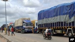 Trucks carrying goods are stranded at the border between Nigeria and Niger in Jibia, Nigeria, on Aug. 7, 2023. The West Africa regional bloc's decision to shut borders with Niger in sanctioning the country's coup plotters is affecting Nigerian towns.