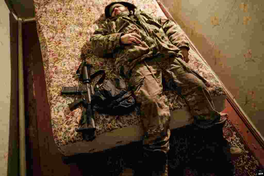 A Ukraine Army serviceman rests on a bed after returning from the frontline, at a rest and recovery base in the Donetsk region.