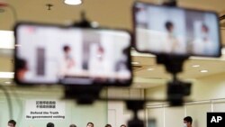 FILE - Representatives of Hong Kong media organizations attend a news conference in Hong Kong, Sept. 24, 2020.