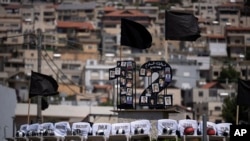 Photos of the12 children and teens, killed in a rocket strike at a soccer field, and chairs with their names are seen displayed on a roundabout in the village of Majdal Shams, in the Israeli-annexed Golan Heights.