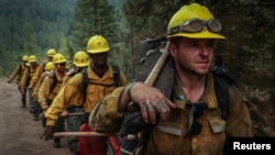 Joshua Tucker-Jonas, 29, an inmate and member of Arcadia 20, marches along a forest road with other members during fire mop up activities on deployment at the Oregon fire near Deer Park, Washington, Aug. 30, 2023.