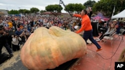 Travis Gienger of Anoka, Minn., reacts after winning the Safeway 50th annual World Championship Pumpkin Weigh-Off in Half Moon Bay, Calif., Monday, Oct. 9, 2023. Gienger won the event with a pumpkin weighing 2749 pounds. (AP Photo/Eric Risberg)