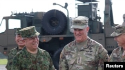 U.S. Army Pacific (USARPAC) Commanding General Charles A. Flynn reacts with General Yoshida Yoshihide, Ground Self-Defense Force Chief of Staff at a Ground Self-Defense Force base on Amami Oshima island, Japan, Sept. 8, 2022. 