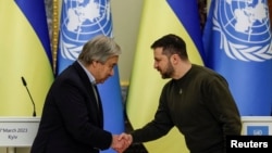 Ukraine's President Volodymyr Zelenskyy and United Nations Secretary-General Antonio Guterres shake hands in Kyiv, Ukraine, after a joint news briefing during Russia's attack on Ukraine, March 8, 2023.