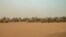 FILE — Vehicles of the Rapid Support Forces (RSF) paramilitaries await before leaving following a rally for supporters of Sudan's ruling Transitional Military Council (TMC) in the village of Abraq, June 22, 2019.
