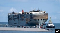 The cargo ship <em>Fremantle Highway, </em>which caught fire while transporting thousands of cars from Germany to Singapore, is towed into the port of Eemshaven, the Netherlands. The ship burned for almost a week close to busy North Sea shipping lanes and a huge migratory bird habitat. It will be taken to the northern Dutch port. 
