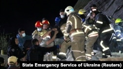 Emergency workers rescue a man from a residential building heavily damaged by a Russian missile strike, on outskirt of the city of Dnipro, Ukraine June 3, 2023.