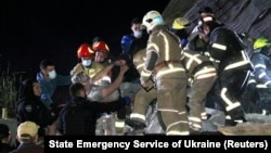 Emergency workers rescue a man from a residential building heavily damaged by a Russian missile strike, on outskirt of the city of Dnipro, Ukraine June 3, 2023.