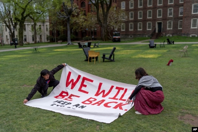 FILE - Demonstrators open a sign after removing their encampment protesting the Israel-Hamas at Brown University, Tuesday, April 30, 2024, in Providence, R.I. (AP Photo/David Goldman)