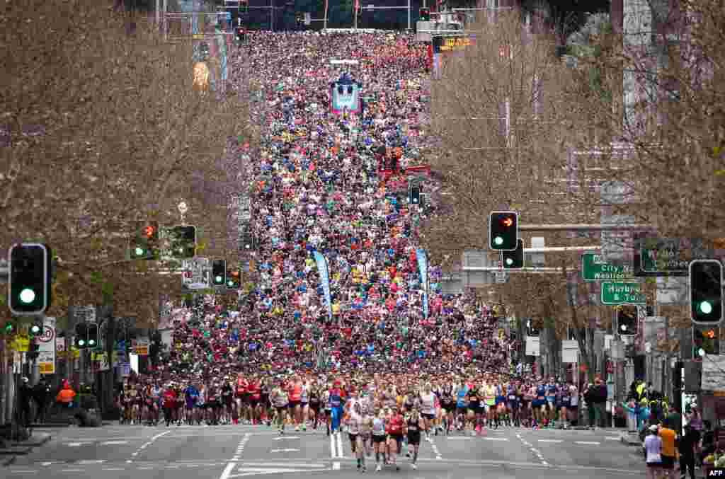 Participants run at the start of the annual City to Surf fun run in Sydney, Australia.