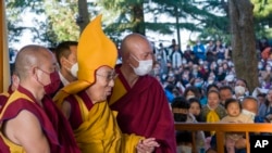 Tibetan spiritual leader the Dalai Lama in a ceremonial yellow hat arrives at the Tsuglakhang temple to give a sermon in Dharamsala, India, March 7, 2023. 