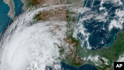 This satellite image provided by NOAA on Oct. 19, 2023, shows Hurricane Norma approaching the southern tip of the Baja California peninsula on Mexico's Pacific coast.