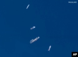 In this satellite image, from top to bottom, the vessels L'Atalante, Horizon Arctic, Deep Energy and Skandi Vinland search for the missing submersible Titan, June 22, 2023, in the Atlantic Ocean. (©2023 Maxar Technologies via AP)
