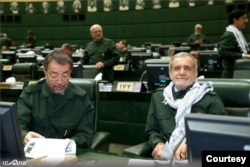 Masoud Pezeshkian, right, and other lawmakers wear IRGC uniforms in parliament in a show of support for Iran's top military force on April 9, 2019, one day after the U.S. designated it a Foreign Terrorist Organization. (Courtesy ICANA)