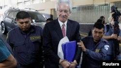 FILE - Journalist Jose Ruben Zamora Marroquin, founder and president of the newspaper El Periodico, is escorted by police officers after being sentenced at a court in Guatemala City, Guatemala, June 14, 2023. 