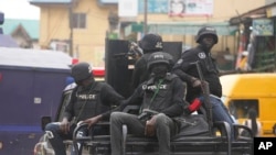 FILE: Police officers patrol during a protest by Nigeria Labor Congress in Lagos, Nigeria, on July 26, 2022. Nigeria's police chief says hundreds of thousands of security forces are being deployed to ramp up safety ahead of the country's Feb. 25 presidential election.