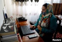 Sana, an Afghan teacher, teaches during an online class, at her house in Kabul, Afghanistan, February 28, 2023. (REUTERS/Ali Khara)