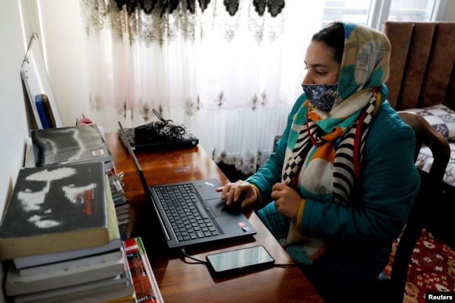 Sana, an Afghan teacher, teaches during an online class, at her house in Kabul, Afghanistan, February 28, 2023. (REUTERS/Ali Khara)