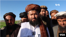 Aminullah Taib, deputy Taliban governor of Badakhshan, Afghanistan, explains to residents that the Taliban will not allow people to grow poppies.
