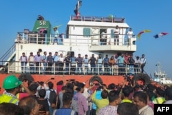 Family members greet the crew of MV Abdullah ship upon their arrival at the Chattogram Port in Bangladesh on May 14, 2024, following their release by the Somali pirates.