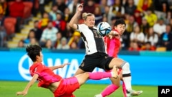 South Korea's Kim Hye-ri kicks the ball clear of Germany's Alexandra Popp in a World Cup match in Brisbane, Australia, on Aug. 3, 2023.