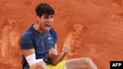 Spain's Carlos Alcaraz celebrates after winning his men's singles final match against Germany's Alexander Zverev on Court Philippe-Chatrier on day fifteen of the French Open tennis tournament at the Roland Garros Complex in Paris, June 9, 2024. 