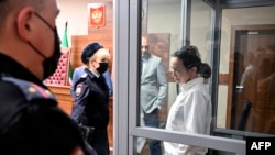 Alsu Kurmasheva, right, a journalist for U.S.-funded Radio Free Europe/Radio Liberty who was arrested last year for failing to register as a "foreign agent," attends a hearing on the extension of her pre-trial detention, at a court in Kazan, Russia, April 1, 2024. 