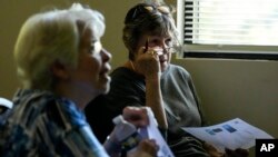 FILE - People listen to an artificial intelligence seminar at the Forsyth County Senior Center, June 25, 2024, in Cumming, Ga.