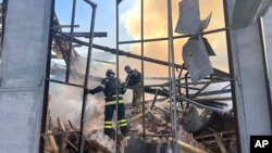 FILE - In this photo provided by the Ukrainian Emergency Service, emergency services personnel work to extinguish a fire following a Russian attack in Kryvyi Rih, Ukraine, Sept. 8, 2023. 