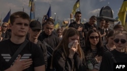 People attend the funeral ceremony for Ukrainian soldier Nazary Gryntsevych, who was killed on the battlefield, at a football stadium in Vinnytsia, Ukraine, on May 10, 2024.