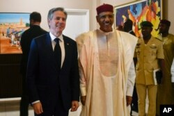 FILE - U.S. Secretary of State Antony Blinken, left, poses for a photo with Nigerien President Mohamed Bazoum during their meeting at the presidential palace in Niamey, Niger, on March 16, 2023.