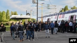 FILE - French Police prevent migrants from boarding a train at des Fontinettes railway station in a new policing strategy to hinder clandestine crossings of the Channel, in Calais, northern France on April 29, 2024.