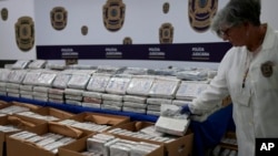 FILE - Seized packets with cocaine are displayed for the media at the Portugal's police headquarters in Lisbon, May 2, 2023. 