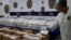FILE - Seized packets with cocaine are displayed for the media at the Portugal's police headquarters in Lisbon, May 2, 2023. 