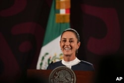 FILE - President-elect Claudia Sheinbaum smiles during a press conference at the National Palace in Mexico City, June 10, 2024.