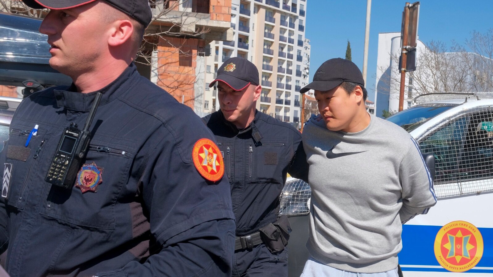 Montenegrin police officers escort an individual who is believed to be fugitive Terraform Labs founder Do Kwon, a South Korean citizen, in Montenegro's capital Podgorica, March 24, 2023.