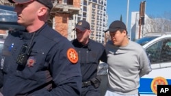Montenegrin police officers escort an individual who is believed to be fugitive Terraform Labs founder Do Kwon, a South Korean citizen, in Montenegro's capital Podgorica, March 24, 2023.