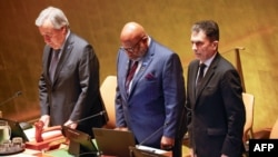 U.N. Secretary-General António Guterres, left, stands during a moment of silence during a United Nations General Assembly tribute to the late Iranian President Ebrahim Raisi at U.N. headquarters in New York on May 30, 2024. 